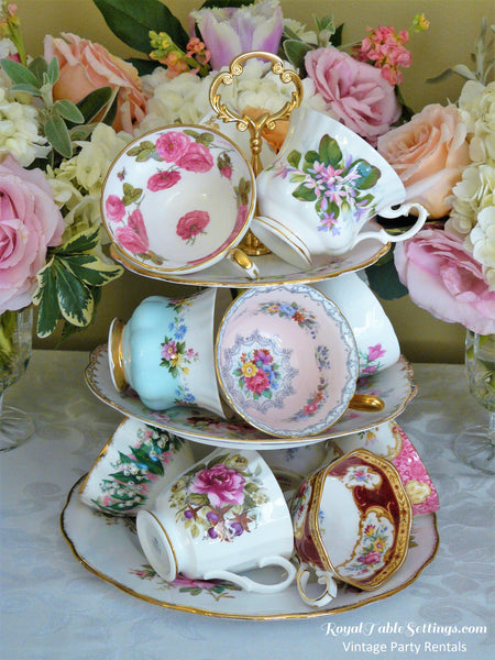 Teacups displayed on a 3-tier stand. Royal Table Settings Tea cups. Vintage Party rentals. Over 300 tea cups for rent for your event.