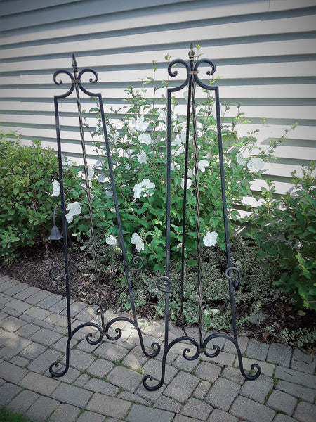 Large Black Pointed Scroll Floor Dipslay Easel.  Display your Art, Pictures or Corporate Signage. Choose from 6 different Easel Styles to rent. Royal Table Settings Vintage Party Rentals.