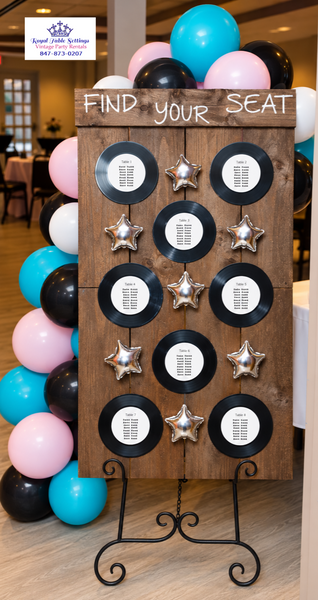 A wooden 'Find Your Seat'  board on a black metal stand Party Rental by Royal Table Settings 