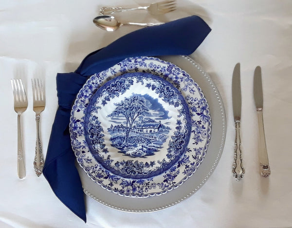 Blue and White Vintage Plates on Silver charger for Rent. Party Rentals by Royal Table Settings.