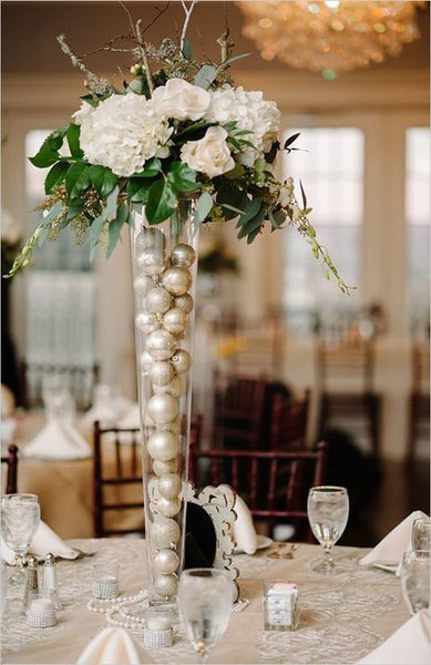 Pilsner Vase filled with ornaments inside  the vase and then toped with flowers. Party Rentals by Royal Table Settings